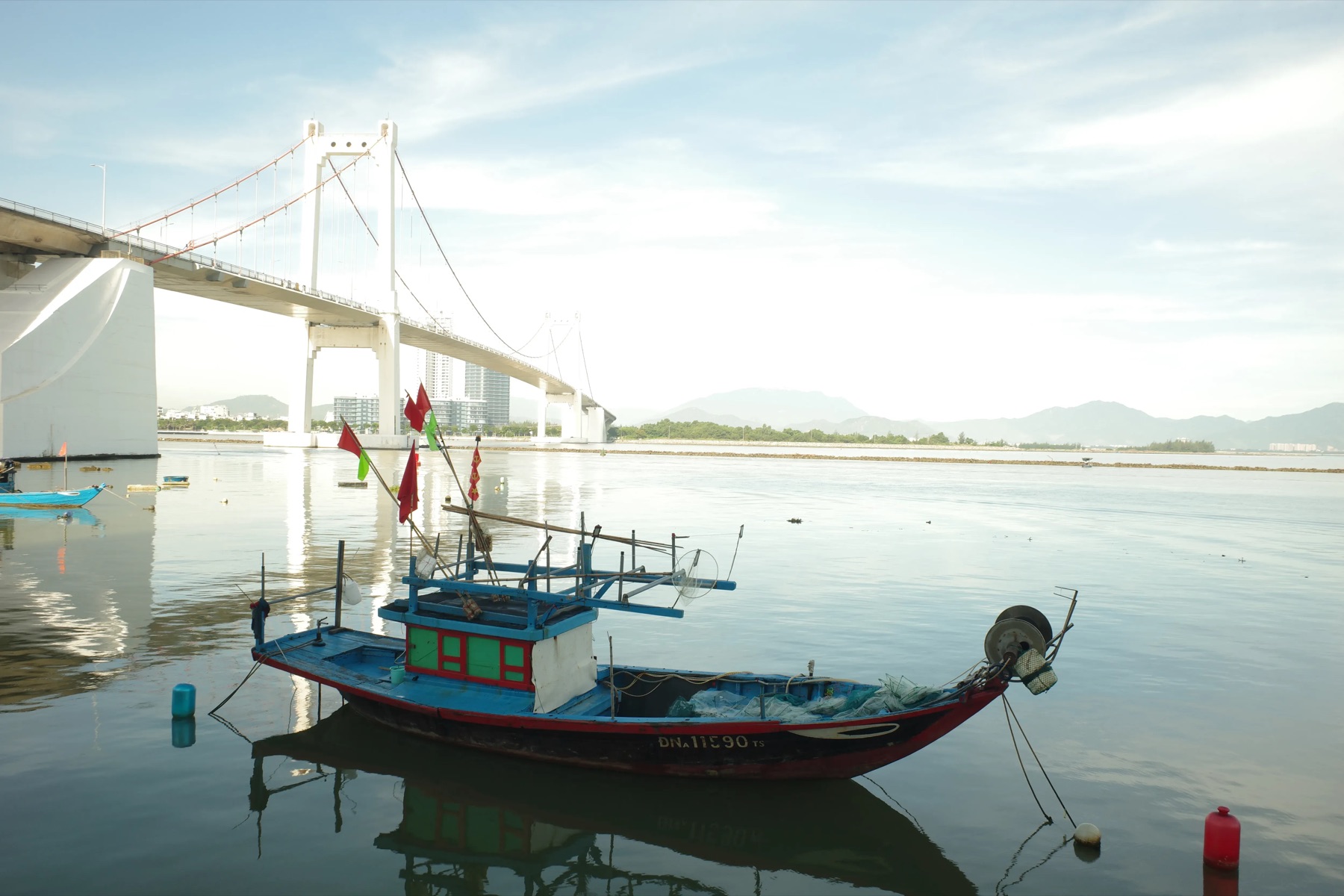 Fishing boat and the suspension bridge, Vietnam