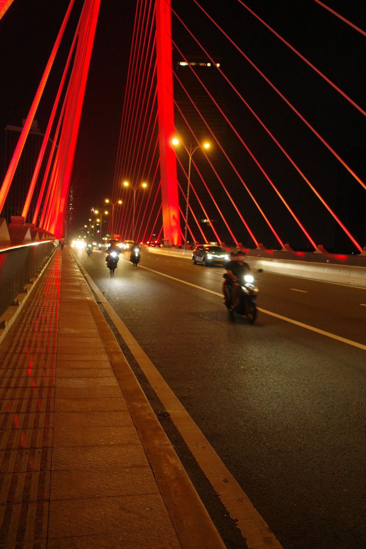 Motorbikes on the red bridge at night